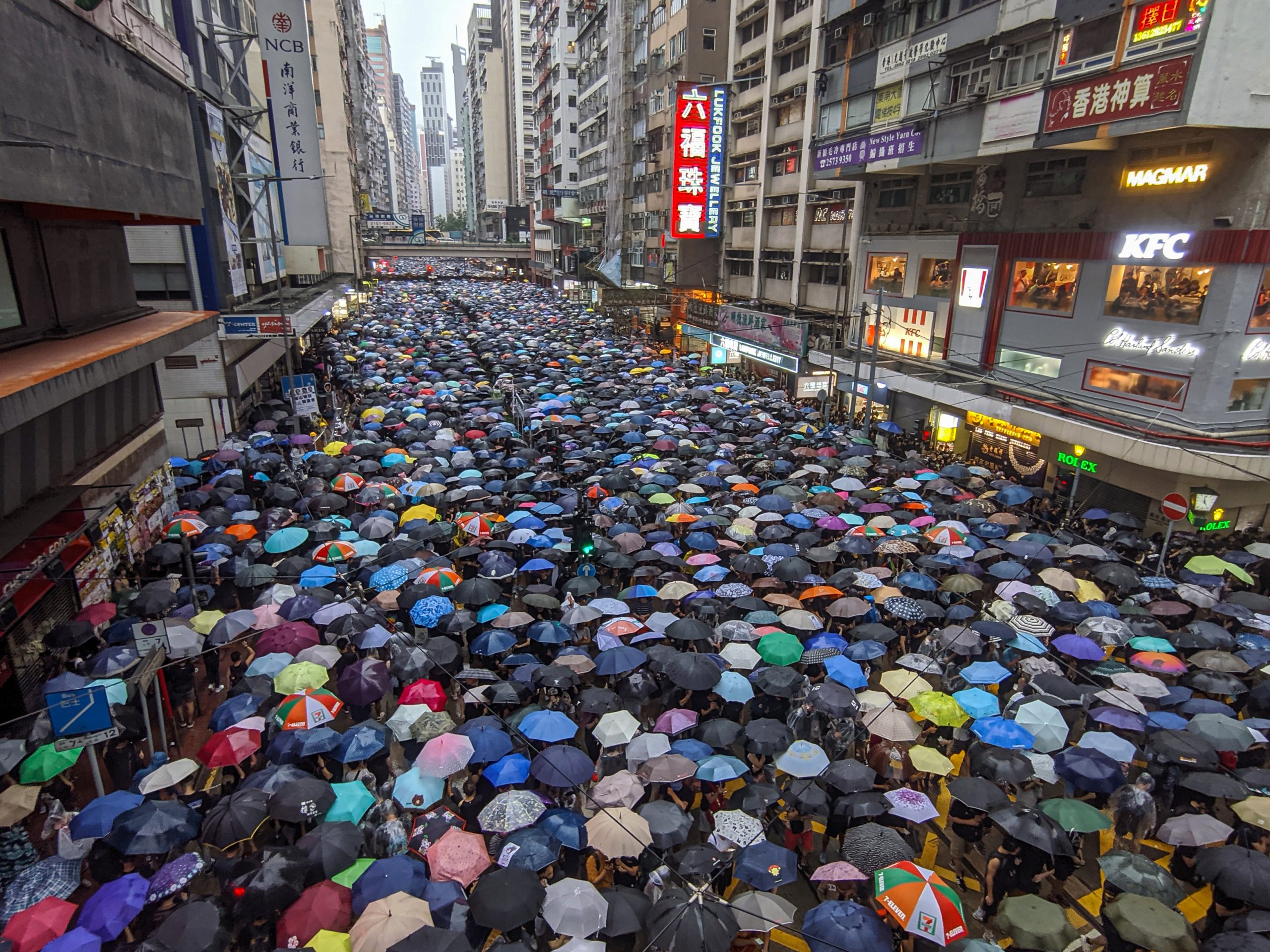 Protests in streets of Hong Kong where protesters hold umbrellas