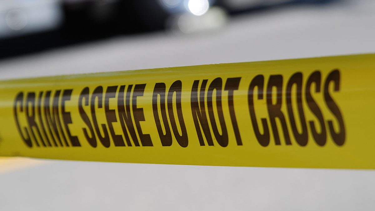A image of yellow tape, with the words “crime scene do not cross” in capital letters.