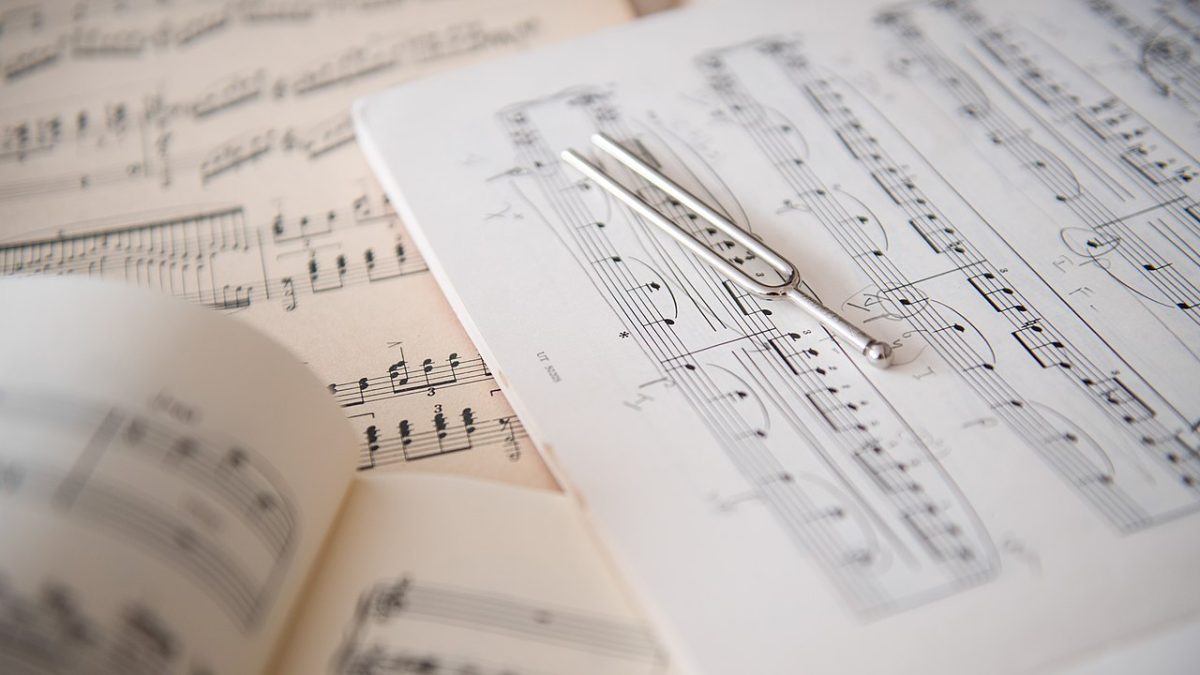 A tuning fork placed on sheet music