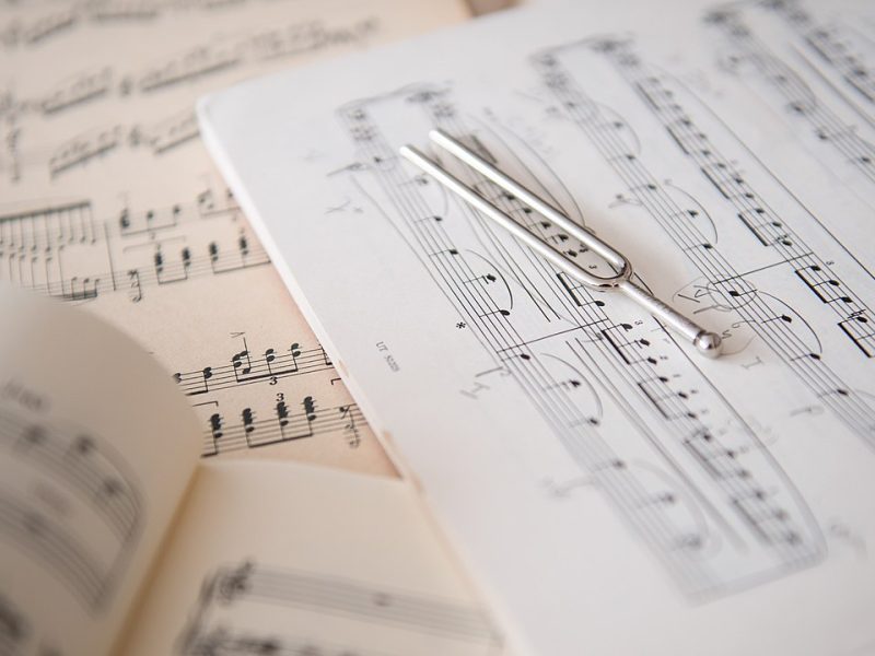 A tuning fork placed on sheet music