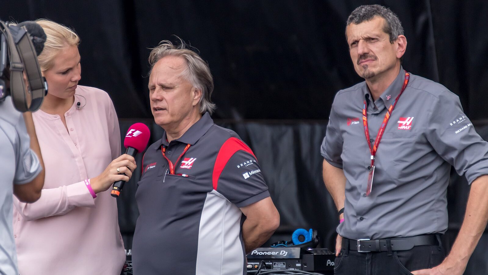 A photograph of Guenther Steiner alongside interviewers