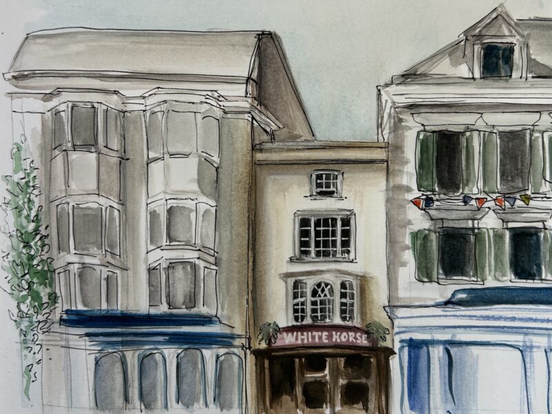 A watercolour of three buildings in Oxford, the centre-most being the pub 'The White Horse.'