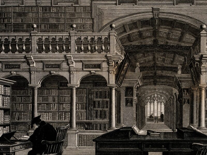 Black and white old illustration of a reading room in the Bodleian Library showing one student studying at a desk, surrounded by bookshelves. "File:Bodleian Library, Oxford; interior showing study desks. Line Wellcome V0014204.jpg" is licensed under CC BY 4.0.