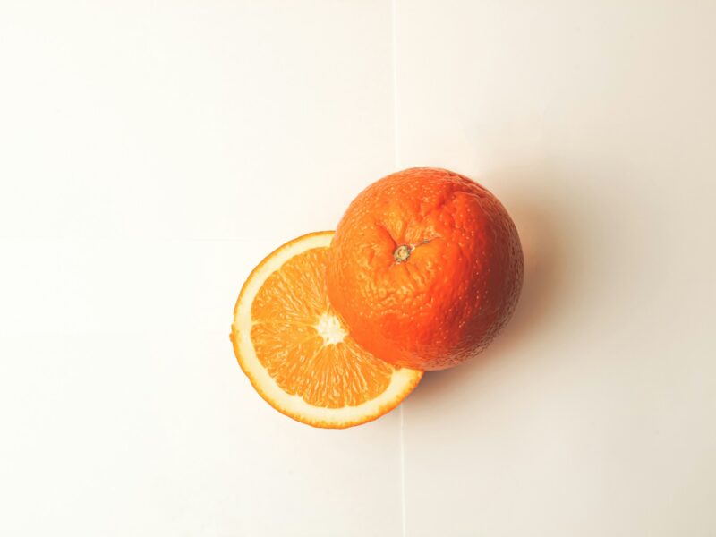 A sliced orange on a white table.