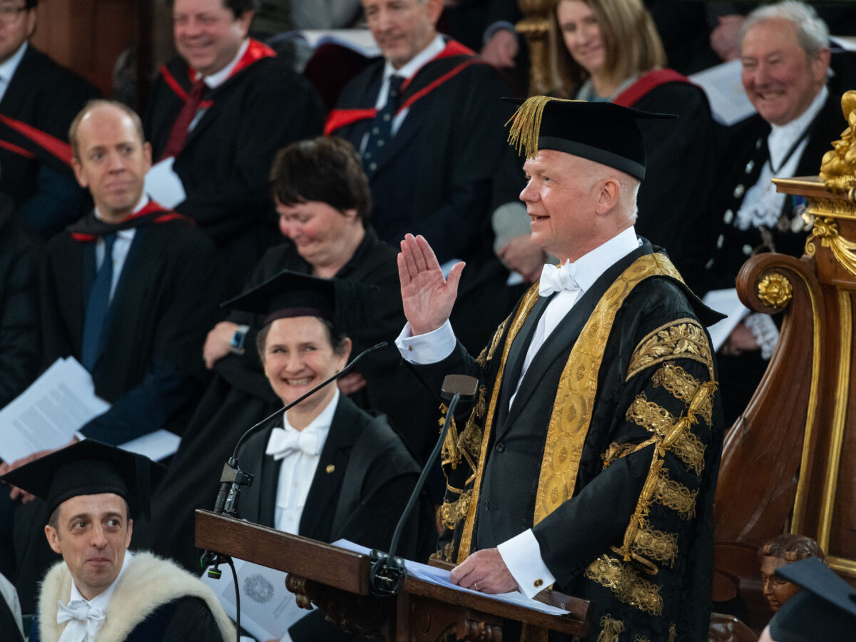 Lord Hague, in ceremonial Chancellor gown, gestures in his speech