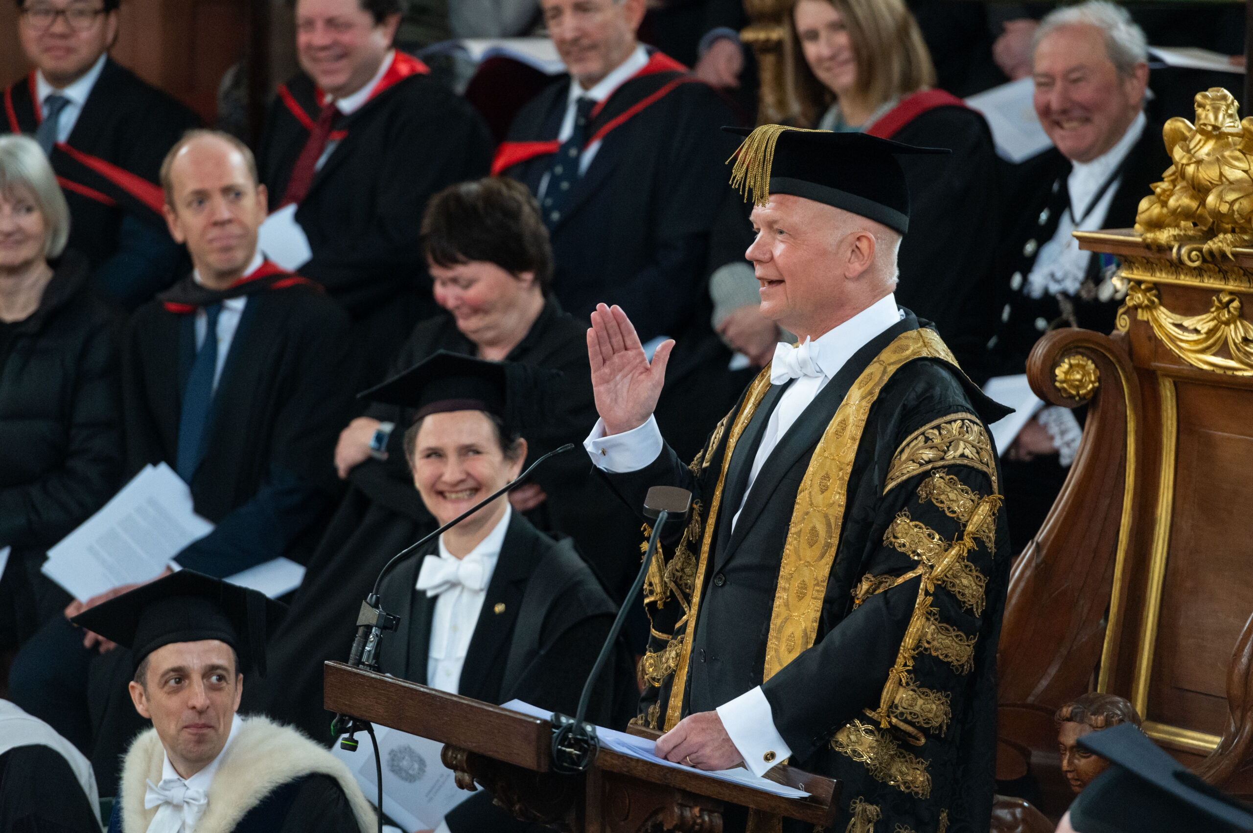 Lord Hague, in ceremonial Chancellor gown, gestures in his speech