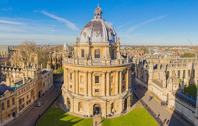 Radcliffe Camera, a cylindrical library in central Oxford, is pictured centrally among the Oxford skyline, as taken from University Church