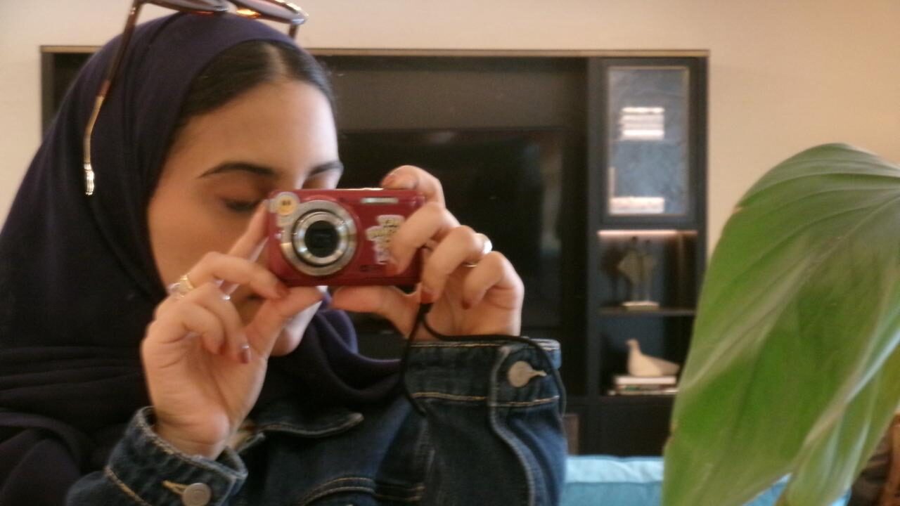 The author of the article is taking a 'mirror selfie' with a digital camera.