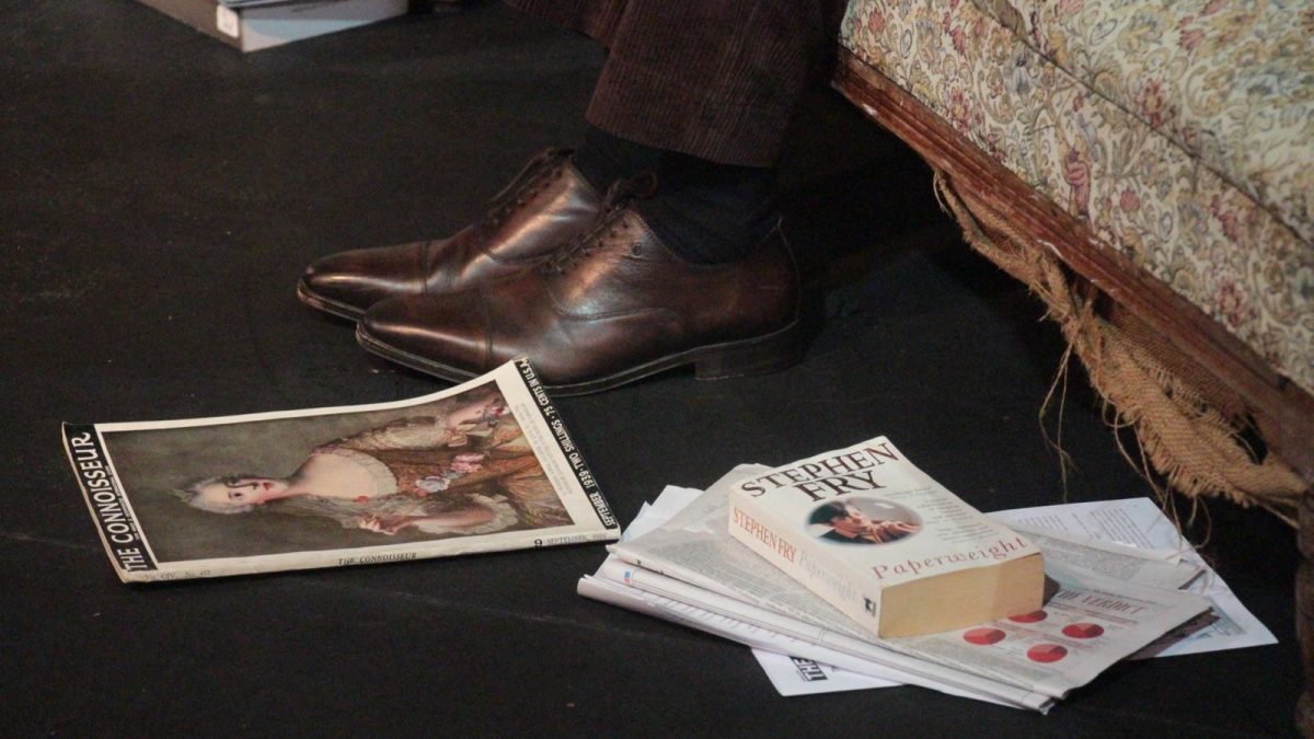 A photo of shoes, magazines and books on the set of the show