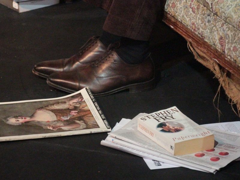 A photo of shoes, magazines and books on the set of the show