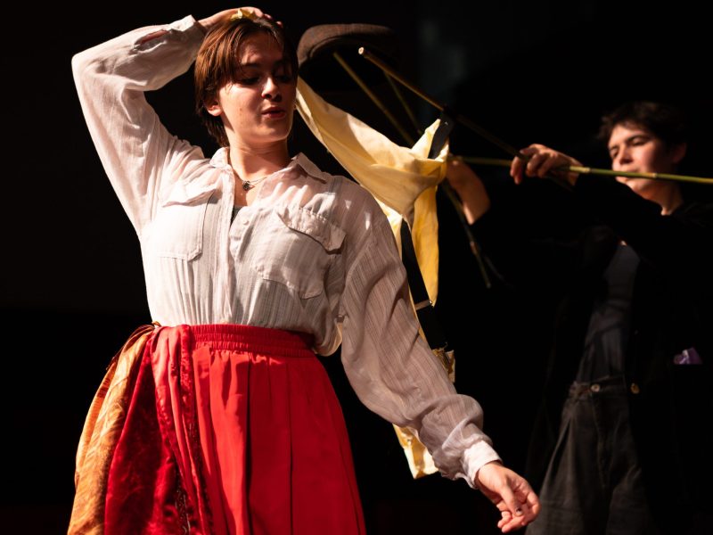 A photo of a cast member in costume, a puppet and a puppeteer