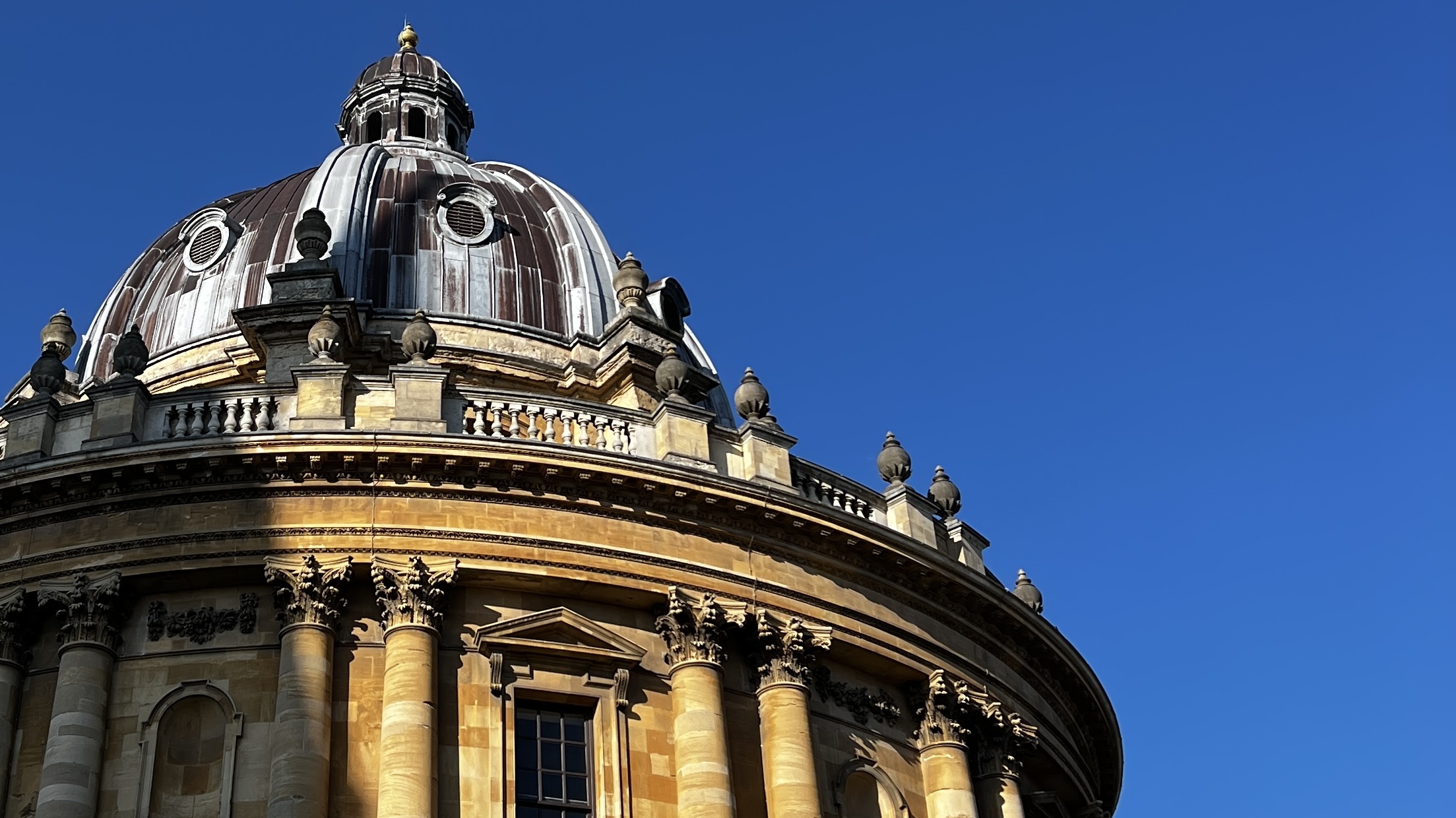 An image of the Radcliffe Camera against a blue sky