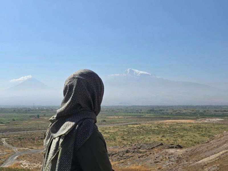 A girl looking out into the distance in a field