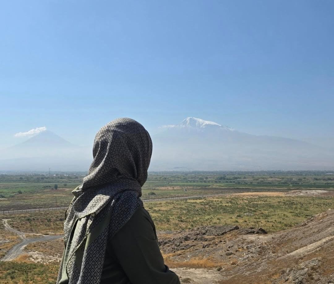 A girl looking out into the distance in a field