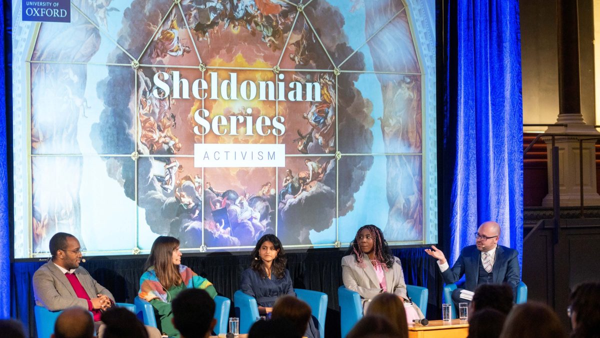 The panel and moderator seated on stage at the Sheldonian Series talk on 'The Power of Activism'.