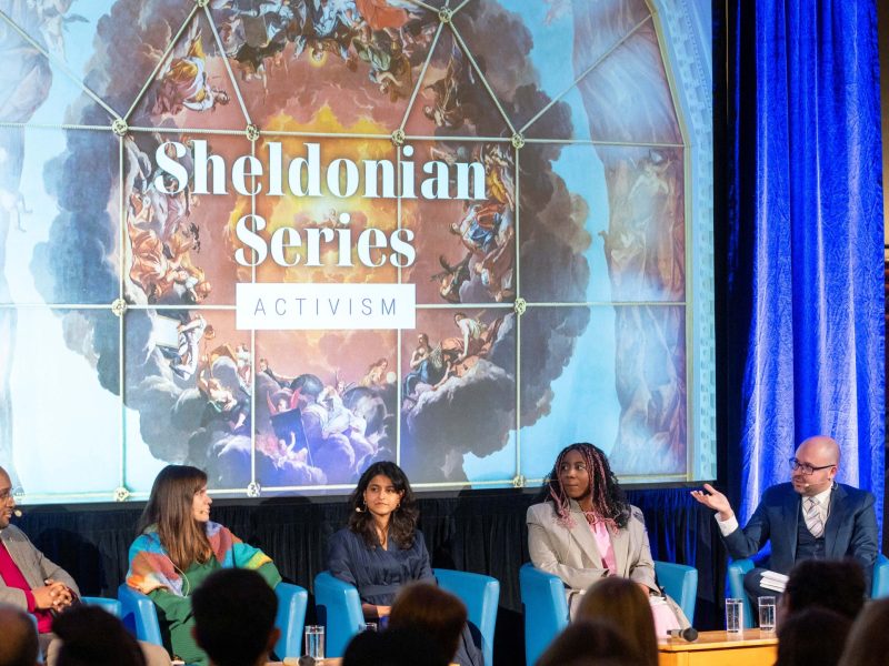 The panel and moderator seated on stage at the Sheldonian Series talk on 'The Power of Activism'.
