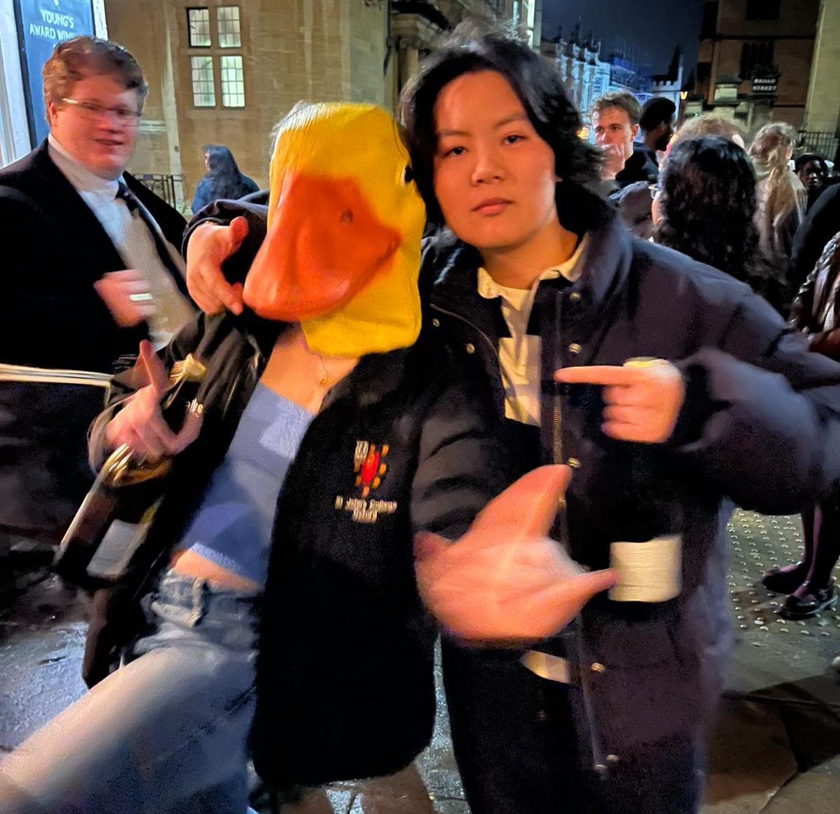 Two students at a cast party, one of them wearing a rubber duck head.