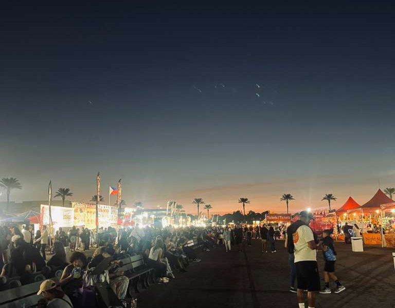 People outside at dusk.