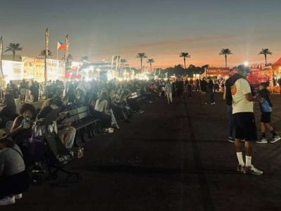 People outside at dusk.