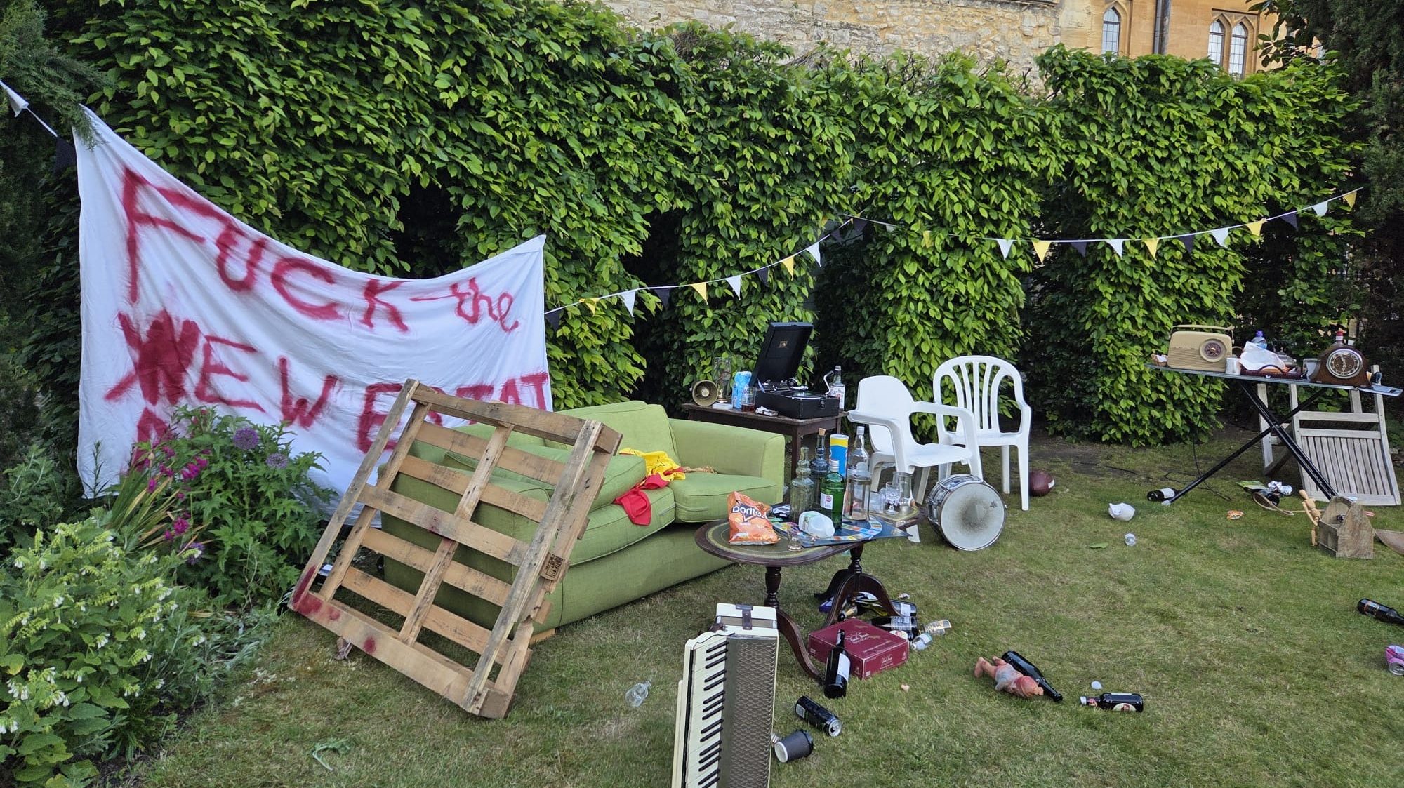 A garden, covered in litter and assorted furniture.