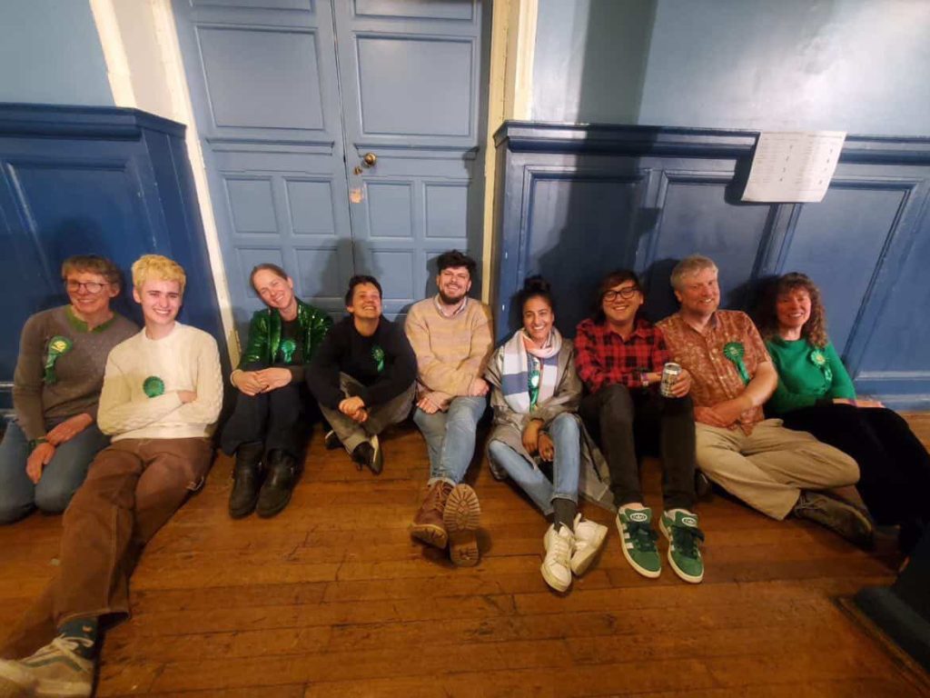 Successful Green councillors sit together.