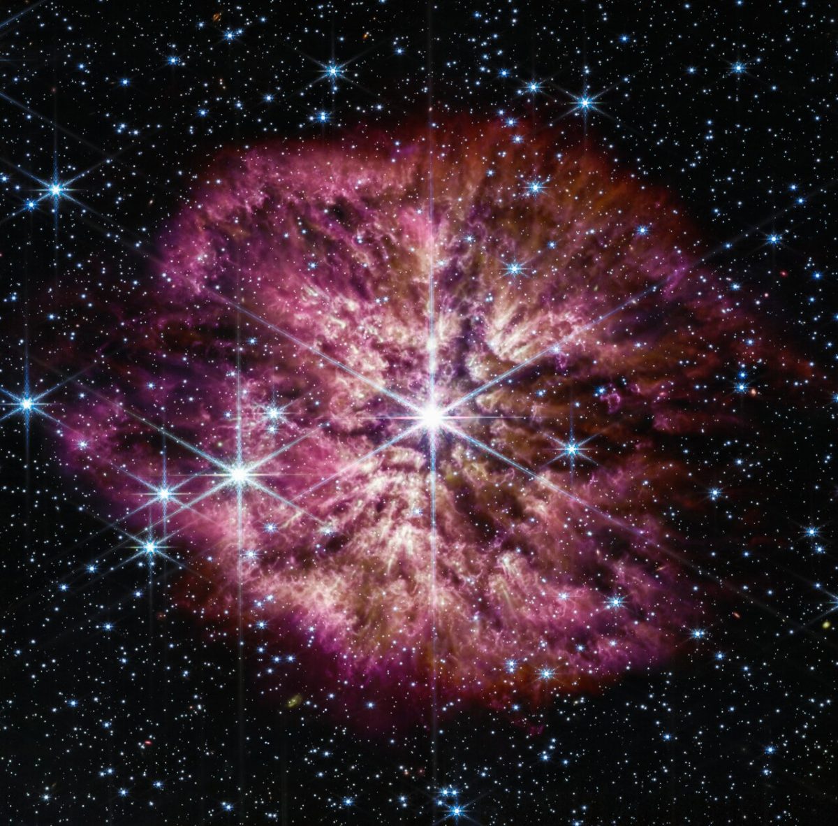 The star Wolf-Rayet 124 (WR124) shines at the centre of an image taken by the NASA/ESA/CSA James Webb Space Telescope. Background stars and galaxies surround WR 124.