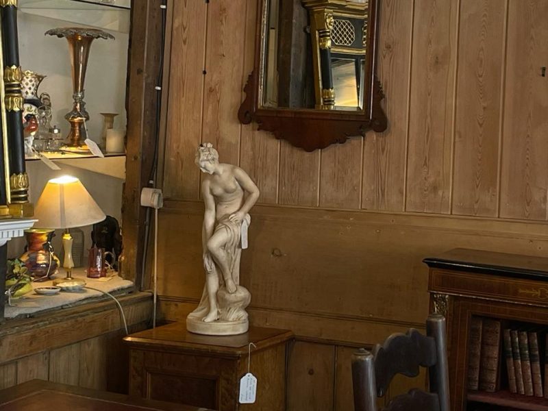 an image of a classical statue in an antique's shop