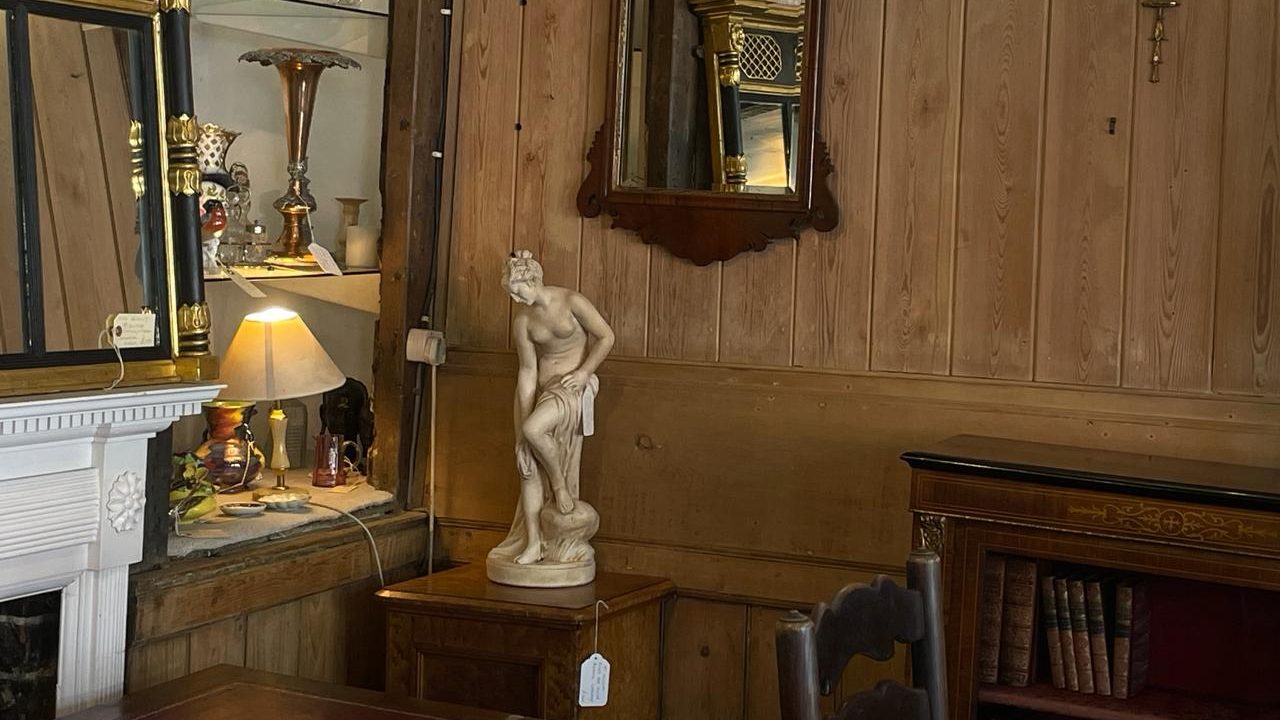 an image of a classical statue in an antique's shop