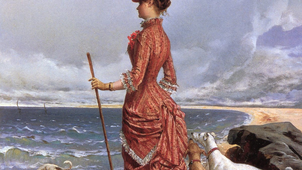 An elegant, old-fashioned lady walking her dogs along a beach