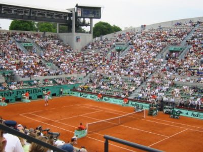 The clay court at Roland-Garros with spectators.