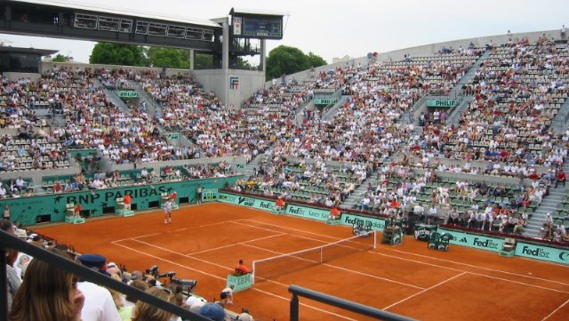 The clay court at Roland-Garros with spectators.