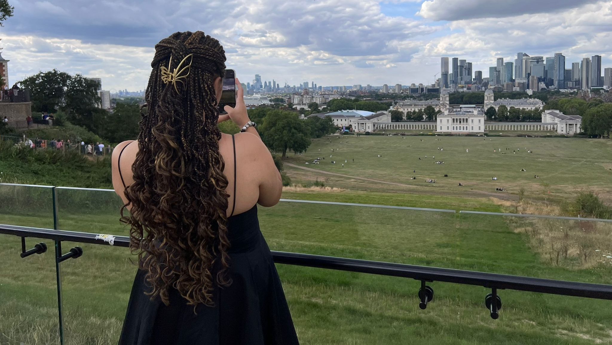 A photo of a girl from behind, showing her braided hair.