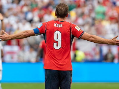 Harry Kane turns away from the camera to celebrate in front of the crowd