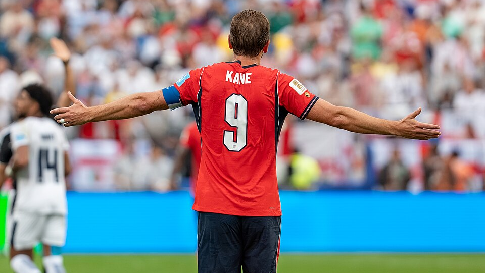 Harry Kane turns away from the camera to celebrate in front of the crowd