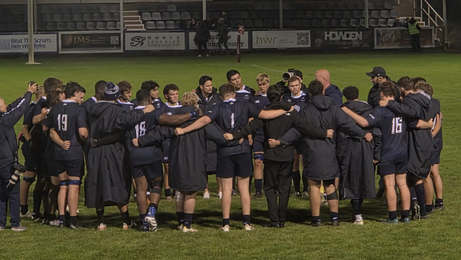 OURFC have a post-match huddle on the pitch.