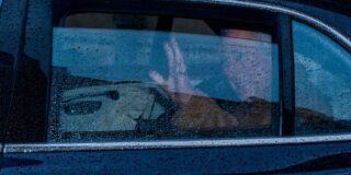 Prince Charles waves goodbye as he leaves Jesus College, Oxford.