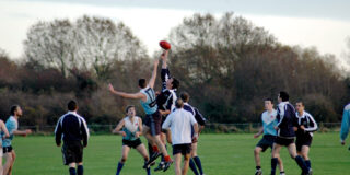 Players compete for the ball in a Varsity AFL match.