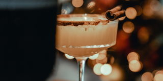 An alcoholic drink sits on a bar.