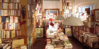 An aesthetic bookshop, filled with books and art.