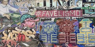An image of a wall in Rio de Janeiro covered in graffiti, with #FAVELISMO at the forefront.