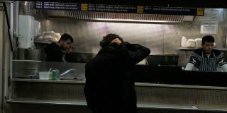 A typical kebab van with a customer standing outside.