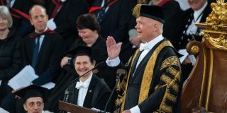 Lord Hague, in ceremonial Chancellor gown, gestures in his speech