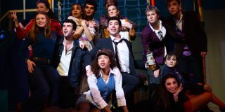 The cast of Company gathered together on the stage