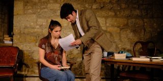 The two protagonists of Oleanna; the professor is reading an essay to his student.