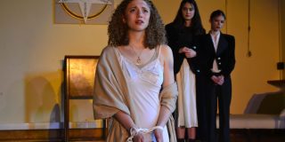Antigone, with her hands tied.