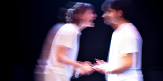 The two characters of The Effect, blurred and in argument