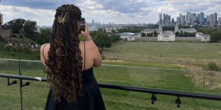 A photo of a girl from behind, showing her braided hair.