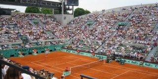 The clay court at Roland-Garros with spectators.