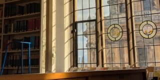 A desk in front a window which looks out onto the Radcliffe Camera